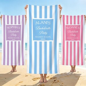 May include: Three rectangular beach towels featuring vertical stripes in lavender, light blue, and pink. Each towel has a central solid-colored rectangle with white text reading Bachelorette Party, a name, Seacrest Beach FL, and 2026.