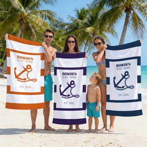 May include: White beach towels with anchor designs and the text "BOWDEN BOAT NAME EST. 2026". One towel has orange stripes and an orange anchor, another has a navy blue anchor and stripes, and the third has a navy blue anchor.