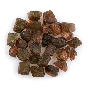 May include: A collection of rough-cut, natural gemstones in shades of brown and olive green. The stones vary in size and shape, with a slightly translucent appearance. The gemstones are scattered on a white background.