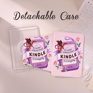 May include: A pink Kindle case with a dragon illustration and the text "A reader without their Kindle is a tragedy." The case is decorated with flowers and a banner. A clear, detachable case is also visible.
