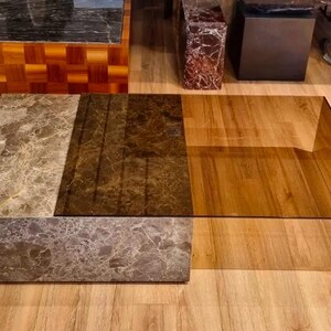 May include: A contemporary coffee table with a rectangular design. The table features marble and wood. The table's dimensions are approximately 152 cm long, 102 cm wide, and 41 cm high.