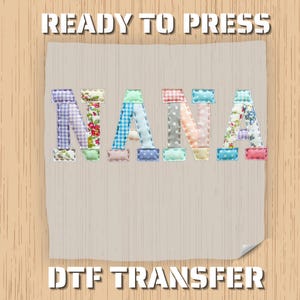 May include: A DTF transfer design with the word "NANA" in patchwork letters. The letters are made of various patterned fabrics, including floral, gingham, and polka dots. The words "READY TO PRESS" and "DTF TRANSFER" are printed above and below the word "NANA".