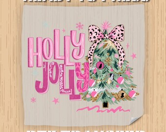 May include: A DTF transfer with a Christmas theme. The design features the words "Holly Jolly" in pink, a decorated Christmas tree with a leopard print bow, and the text "Ready to Press" and "DTF Transfer".