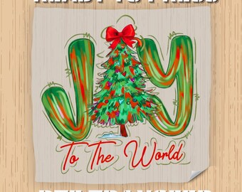 May include: A DTF transfer design featuring the word "JOY" in green and red, with a Christmas tree in the center. The text "To The World" is below the tree, and "READY TO PRESS" and "DTF TRANSFER" are above and below the design.
