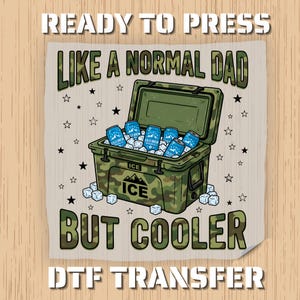 May include: A DTF transfer design featuring a camouflage cooler filled with ice and blue cans of "Cold Brew". The text reads "LIKE A NORMAL DAD BUT COOLER" and "READY TO PRESS" and "DTF TRANSFER".