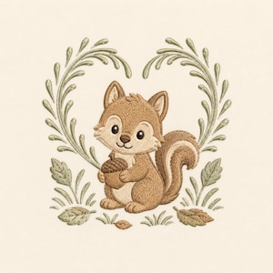 May include: An embroidery design featuring a light brown squirrel holding a dark brown acorn. The squirrel is framed by two curved, light green leafy branches that form a heart shape, with additional leaves and grass at the base.