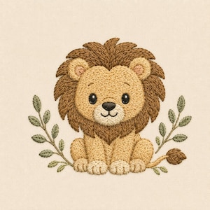 May include: An embroidery design featuring a light tan lion with a dark brown mane, sitting centrally. The lion has black eyes and a black nose. Two symmetrical green leafy branches frame the lion on the left and right sides, set against a cream fabric background.