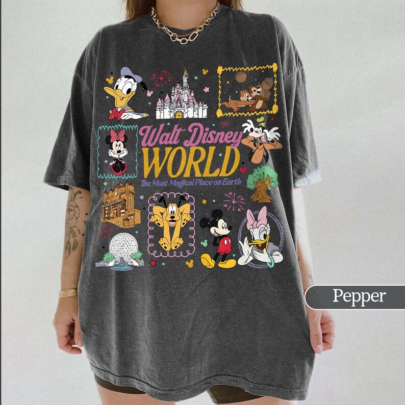 May include: Pepper-colored t-shirt featuring a colorful graphic of various Disney characters and the words "Walt Disney World." The design includes images of Mickey Mouse, Minnie Mouse, Donald Duck, and other beloved characters.