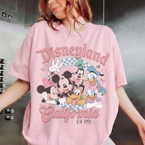 May include: A white ceramic mug with a black handle and the text "But First, Coffee" in a black, handwritten-style font. The mug is on a white surface.