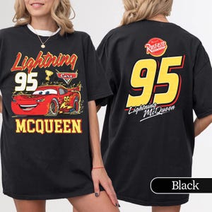 May include: Black t-shirt featuring Lightning McQueen from the Cars film. The front design includes the number 95, the character's name, and a graphic of the race car. The back of the shirt displays the number 95 in yellow with red accents and the Lightning McQueen logo.