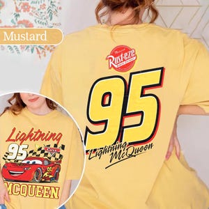 May include: Mustard-coloured t-shirt featuring Lightning McQueen from the Cars film. The front graphic shows the race car with the number 95, while the back displays a large yellow 95 and the Rust-eze logo.