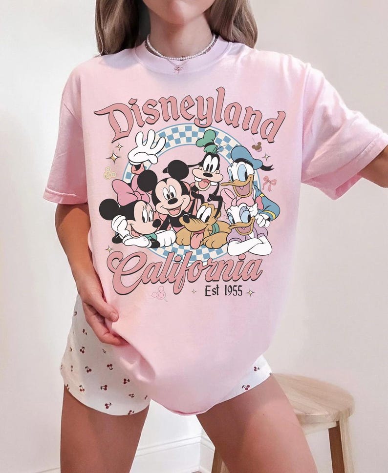 May include: A white ceramic mug with a black handle and the text "But First, Coffee" in a black, bold font. The mug is on a white surface.