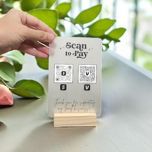 May include: A clear acrylic "Scan to Pay" sign with two QR codes and the text "Thank you for supporting my small business!!" The sign is held in a small wooden base.