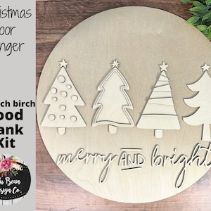 May include: A wooden Christmas door hanger kit with four unfinished wooden Christmas trees and the words "merry and bright" on a round wooden base.