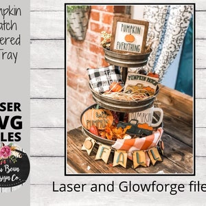 May include: A three-tiered tray decorated with fall-themed items, including a sign that says "Pumpkin Everything", a truck with the words "Pumpkin Patch", and a banner that says "Fall".