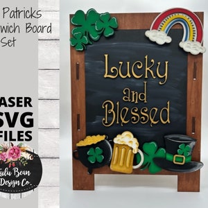 May include: A wooden sandwich board with a chalkboard insert. The chalkboard has the text "Lucky and Blessed" written in gold paint. The board is decorated with shamrocks, a rainbow, a pot of gold, a beer mug, and a leprechaun hat.