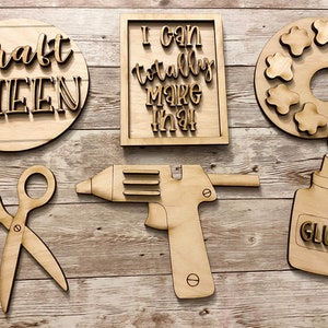 May include: Wooden craft supplies including a paint palette, glue bottle, scissors, glue gun, and signs that say "Craft Queen" and "I can totally make that".