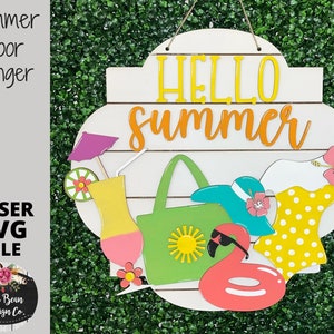 May include: A white wooden door hanger with the text "Hello Summer" in yellow and orange letters. The hanger is decorated with a green beach bag, a blue sun hat, a yellow and white swimsuit, a pink flamingo float, and a yellow cocktail glass with a pink and yellow drink.