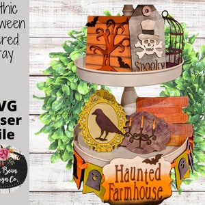 May include: A tiered tray decorated with Halloween themed wooden cutouts. The tray features a black raven, a spooky sign, a tree, a candelabra, and a banner that reads "Haunted Farmhouse".