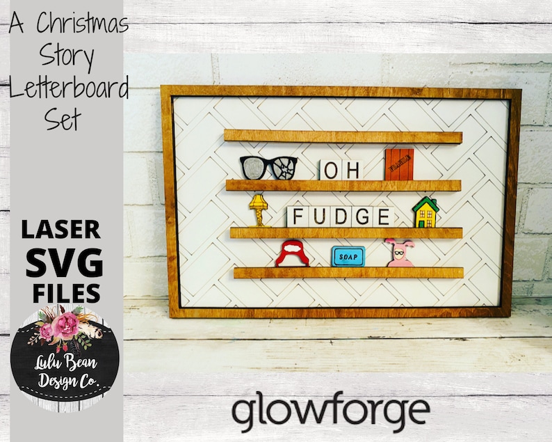 May include: A wooden letterboard set with three shelves, featuring a Christmas Story theme. The shelves are decorated with various characters and objects from the film, including glasses, a lamp, a house, a pig, a red hat, and a bar of soap. The letterboard is made of white tiles with black letters and the words "OH" and "FUDGE" are spelled out on the shelves. The letterboard is framed in a brown wooden frame.