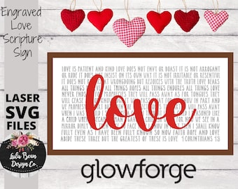 May include: A red and white sign with the word "love" in large red letters. The sign features a scripture about love from 1 Corinthians 13. The sign is framed in brown and has a white background.