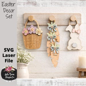May include: Wooden Easter decor set featuring a basket with flowers, feather-shaped ornaments with bows, and a bunny. The set is laser cut and includes the text "Easter Decor Set" and "SVG Laser File".