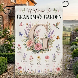May include: A white garden flag with the text "Welcome to GRANDMA'S GARDEN" and a large letter "G". The flag features floral and butterfly illustrations, with names below. A hummingbird and butterflies are also depicted.