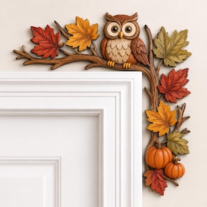 May include: A decorative corner wall accent featuring a brown owl perched on a tree branch. The branch is adorned with autumn-colored maple leaves in shades of red, orange, and yellow, and includes two small orange pumpkins at the bottom section.