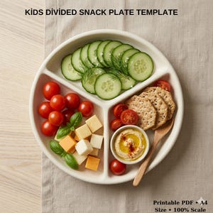 May include: A white, divided snack plate with fresh ingredients, including sliced cucumbers, cherry tomatoes, cheese cubes, crackers, and hummus. The plate is labelled "KIDS DIVIDED SNACK PLATE TEMPLATE" at the top.