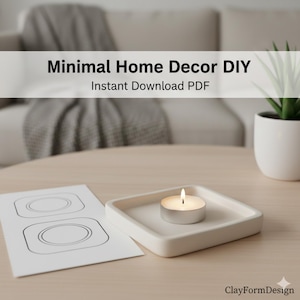 May include: A white square candle holder with a lit tea light candle. A sheet of paper with a design is next to the candle holder. The text "Minimal Home Decor DIY Instant Download PDF" is at the top.