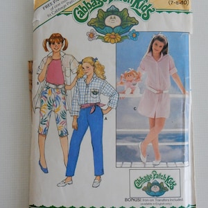 May include: A vintage sewing pattern for Cabbage Patch Kids clothing. The pattern includes instructions for making a pair of jeans, a plaid shirt, and a pink and white striped dress. The pattern is for sizes 7-8-10. The pattern is from Butterick.