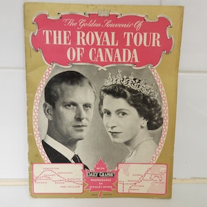 May include: A vintage souvenir booklet with a gold cover and a pink title that reads "The Golden Souvenir of The Royal Tour of Canada". The cover features a black and white photo of Queen Elizabeth II and Prince Philip. The booklet includes a map of Canada with the cities visited by the royal couple.