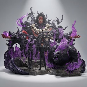 May include: A detailed collectible statue featuring a central male figure in a black shirt and trousers, surrounded by dark, armoured entities, a large bear-like creature with purple flames, and a towering hooded figure adorned with skulls.