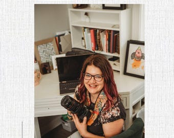May include: A woman with glasses and red hair smiles while holding a camera. The image includes text that reads "Impact the World with Your Business" and "A Guide to Understanding & Elevating Your Brand" by Trae Bohlen. The website photographybytrae.com is also visible.