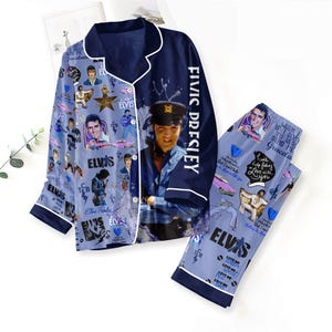 May include: Navy blue pyjama set featuring images of Elvis Presley. The top has a collared neckline and white trim. The pants and top are covered in Elvis-themed graphics and text. The words "Elvis Presley" are printed vertically on the sleeve.