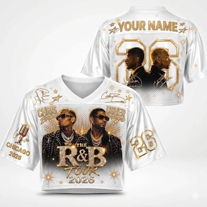 May include: A white V-neck jersey featuring a graphic print of Chris Brown and Usher Raymond, the text "THE R&B TOUR 2026", "CHICAGO 2026", and "YOUR NAME" with the number 26. The design includes gold star accents, a microphone illustration, and signatures.