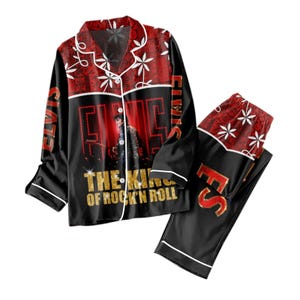 May include: Black pajama set with a red and white floral design on the collar and trousers. The shirt features a graphic of a person and the text "ELVIS" and "THE KING OF ROCK 'N ROLL" in gold lettering.