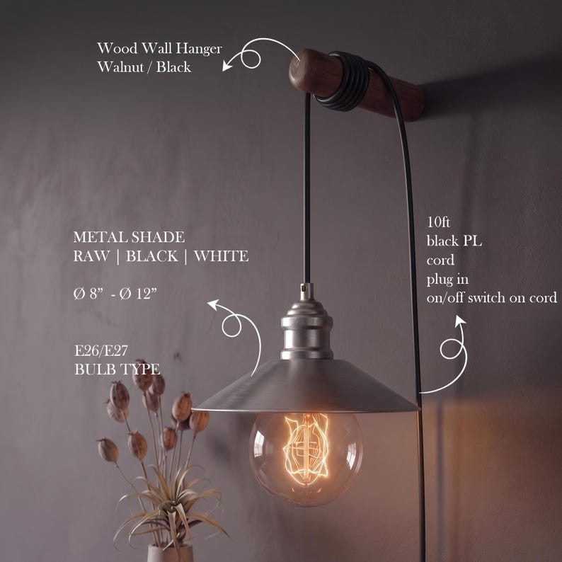 May include: A metal shade pendant light with a raw finish, available in black and white. The light has a diameter of 8 to 12 inches and uses E26/E27 bulbs. It hangs from a walnut and black wood wall hanger with a 10-foot black cord.