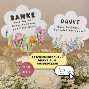 Peut inclure: Deux panneaux en papier en forme de nuage sur bâtonnets avec des illustrations florales à l'aquarelle et du texte en allemand. L'un indique DANKE dass Du mir beim Wachsen geholfen hast! et l'autre DANKE dass Du immer für mich da warst! Inclut une étiquette 2ER SET.