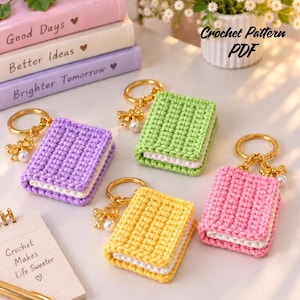 May include: Four miniature crochet book keychains in lavender, lime green, yellow, and pink, each featuring a gold-tone ring, a small gold bow charm, and a white pearl bead. The text Crochet Pattern PDF and Crochet Makes Life Sweeter are visible.