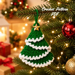 May include: A green crocheted Christmas tree ornament with three tiers of white scalloped trim and a small gold star at the top. The text Crochet Pattern PDF is visible in the upper right corner of the image, hanging from a pine branch.