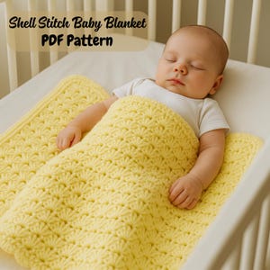 May include: A sleeping baby is nestled under a yellow shell stitch baby blanket in a crib. The blanket is a soft, textured knit with a repeating pattern. The text "Shell Stitch Baby Blanket PDF Pattern" is at the top.