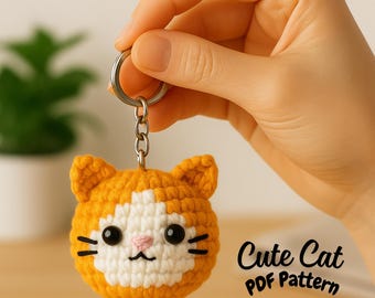 May include: Crocheted orange and white cat keychain with black eyes, whiskers, and a pink nose. The keychain is held by a hand and has a silver ring. The text "Cute Cat PDF Pattern" is visible.