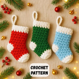 May include: Three miniature crochet Christmas stockings in red, green, and blue with white accents. The stockings are displayed on a neutral surface with festive decorations, including greenery, berries, and ornaments. The text "CROCHET PATTERN" is visible.