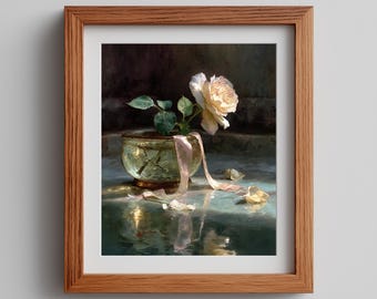 May include: A framed painting featuring a single pale yellow rose in a small, weathered green bowl. A delicate pink ribbon drapes from the bowl onto the surface below, where scattered rose petals rest. The scene is set against a dark, moody background.
