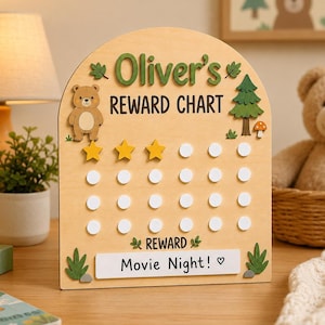 May include: An arched wooden reward chart featuring the text Oliver's REWARD CHART, a cartoon bear, a pine tree, and a mushroom. The board includes three yellow star tokens and rows of white circular slots, with a white label reading Movie Night!