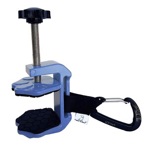 May include: A light blue clamp with a black handle and a black knob. The clamp has a screw mechanism and black pads. A black strap connects the clamp to a black carabiner clip.