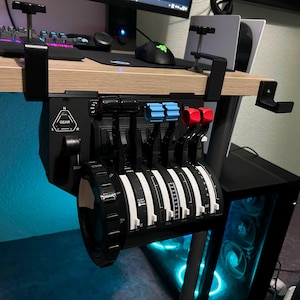 May include: Flight simulator throttle quadrant in black and white, with blue and red levers, mounted under a desk. The throttle features multiple levers and dials for aircraft control. The word "GEAR" is visible on the panel.