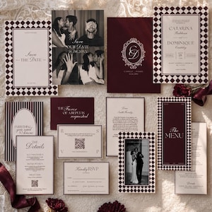May include: A wedding stationery suite featuring deep burgundy and cream paper goods. Items include Save the Date cards with photos, a formal invitation with a checkered border, a menu, RSVP cards with QR codes, and detail cards with elegant serif typography.
