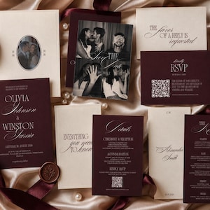 May include: A wedding stationery suite featuring deep burgundy and cream cards with elegant serif typography. The set includes an invitation, RSVP card with a QR code, details card, menu, and a photo card, all accented by a wax seal and ribbons.